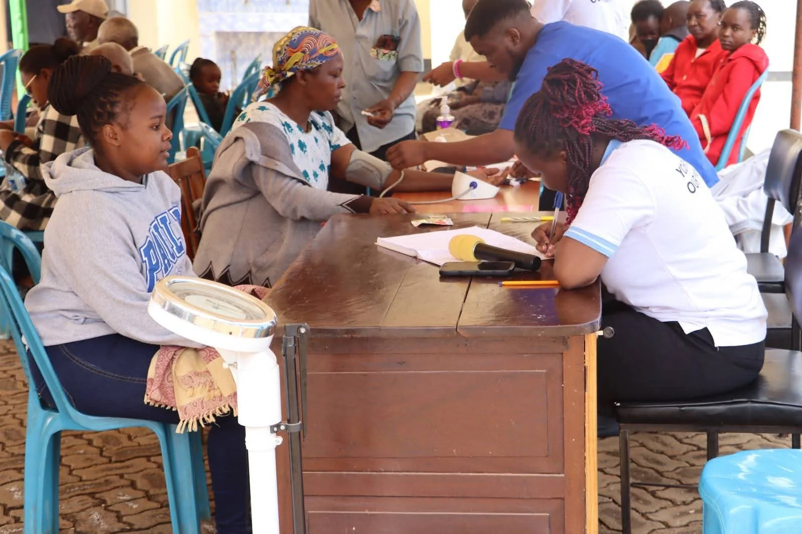 Health checks and patient registration bring the care team together with community members.