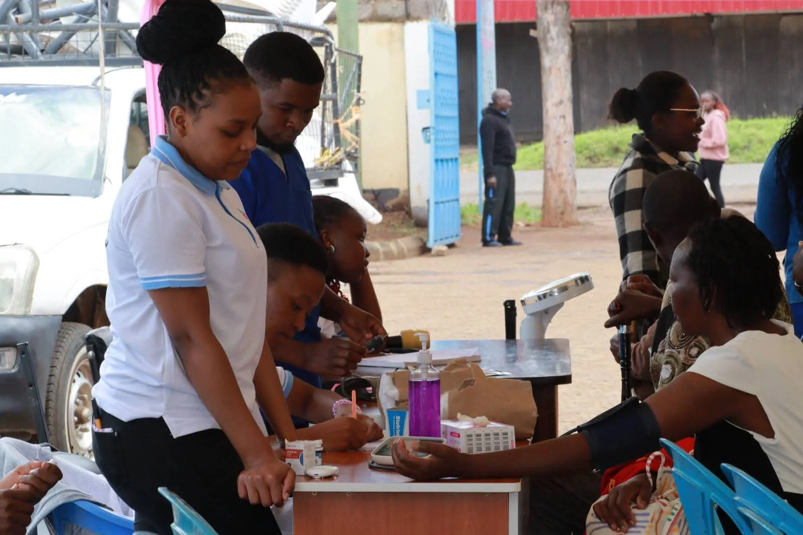 A member of the care team checks blood pressure during a community health outreach.